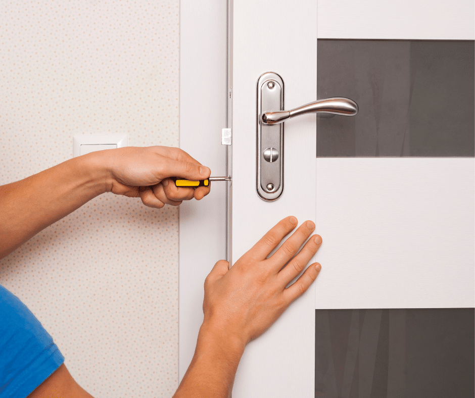 A locksmith technician fixing a lock